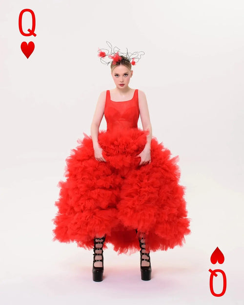 Ankle-length red tulle gown showcasing ethereal movement and elegance.