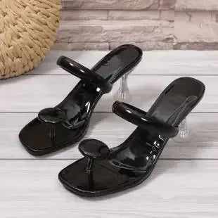 Lightweight black heeled slides designed for comfort and style.