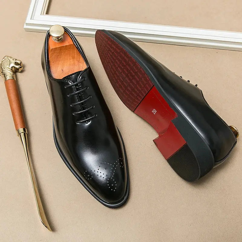 Handcrafted leather oxfords in rich brown with pointed toe design.