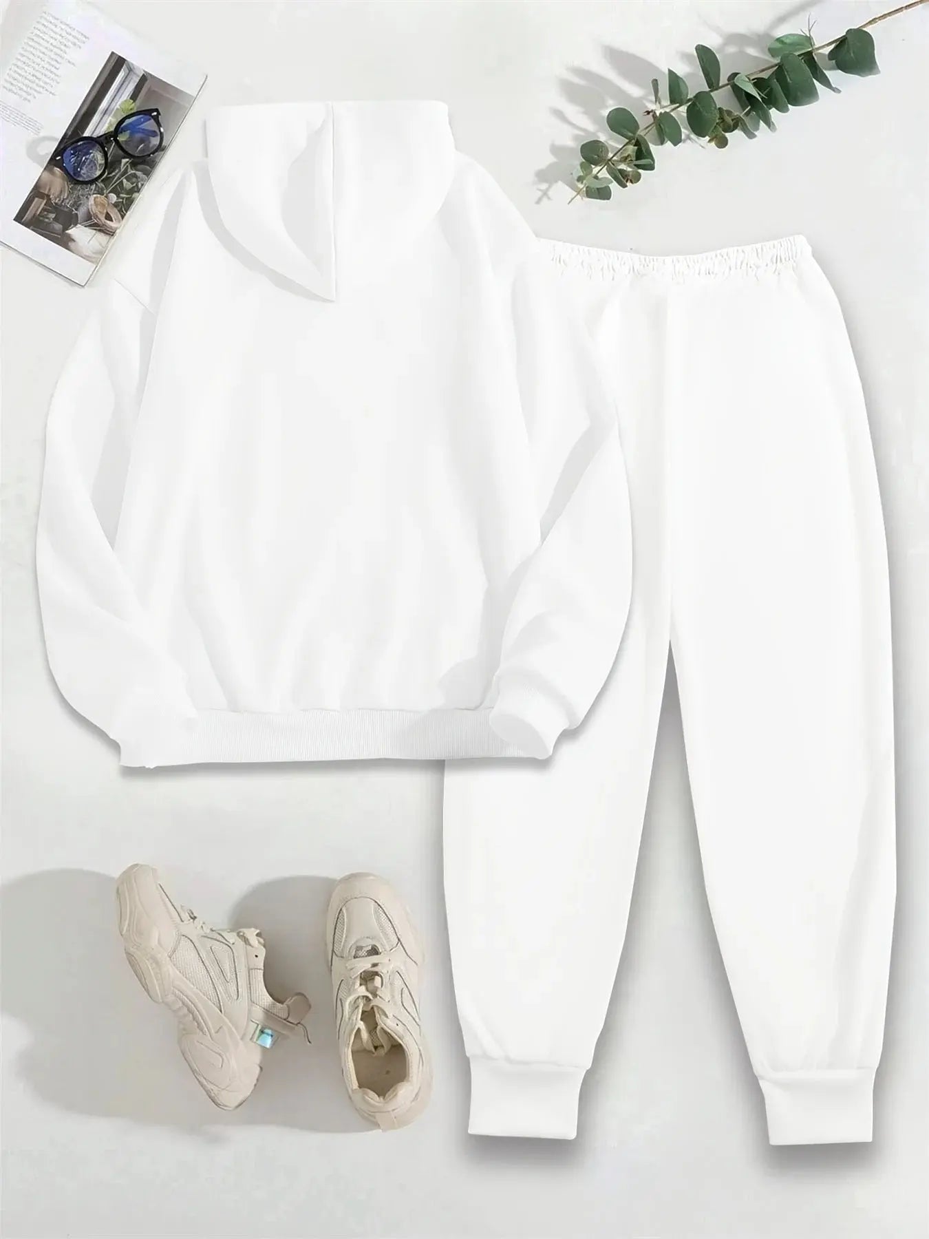 Complete two-piece streetwear outfit with graphic hoodie and matching pants in soft polyester blend