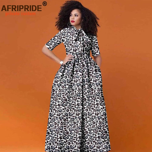 Woman wearing colorful Ankara print maxi dress with flattering high waist and half sleeves
