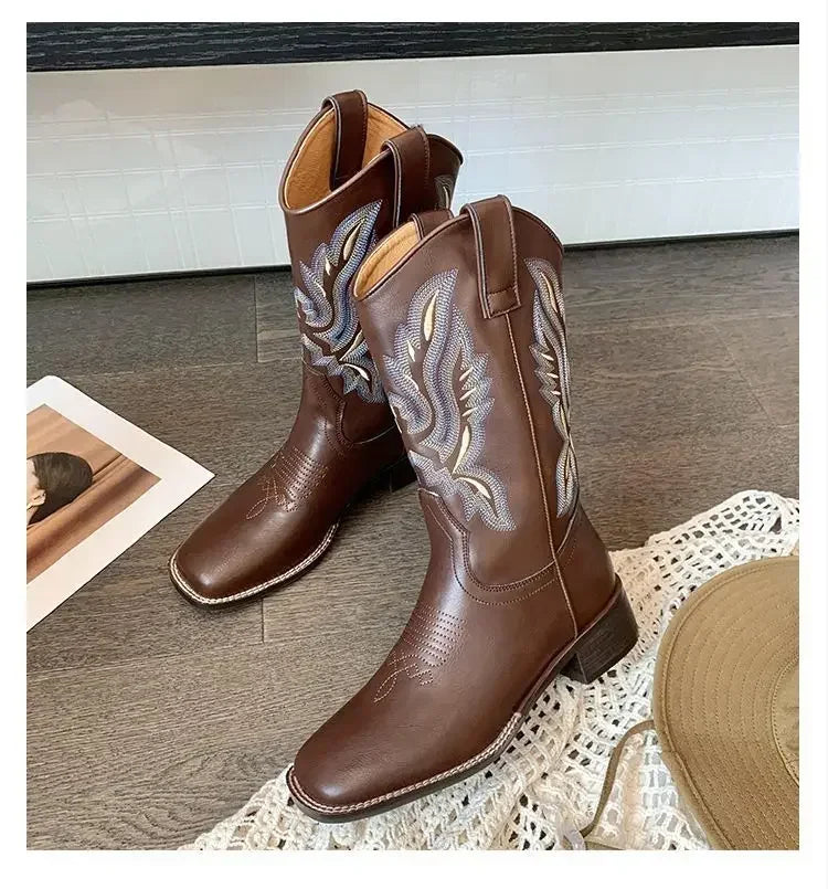 Mid-calf leather boots with intricate embroidery and classic Western boot silhouette