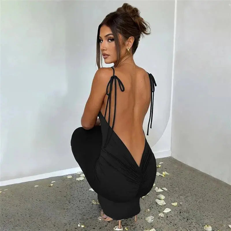 Model wearing the elegant black backless dress, showcasing its slim fit and ankle-length cut.