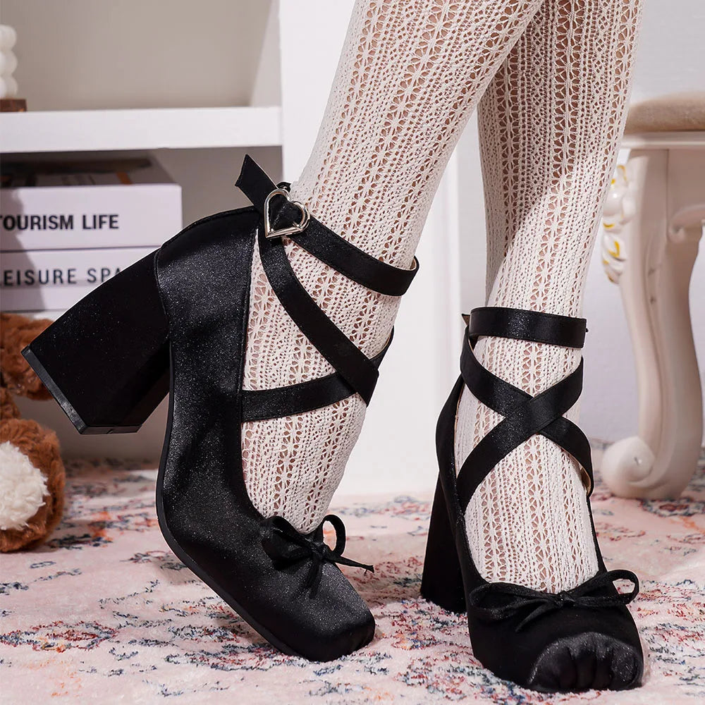 Blush satin heels displayed on a sunlit garden party setting.