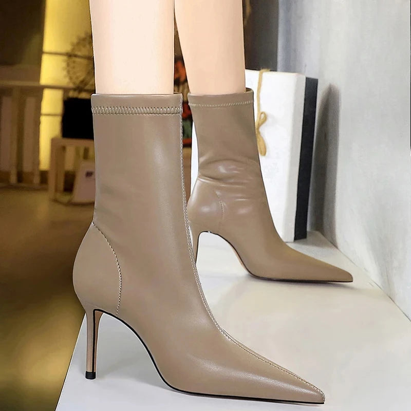 Mid-calf stiletto boots featuring pointed toe and slip-on design
