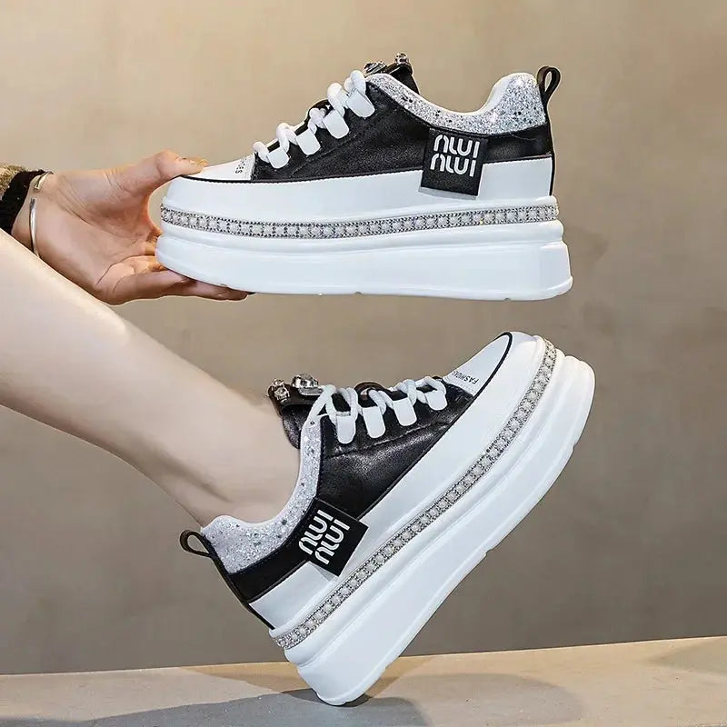 Lace-up closure on stylish black sneakers for a secure fit.