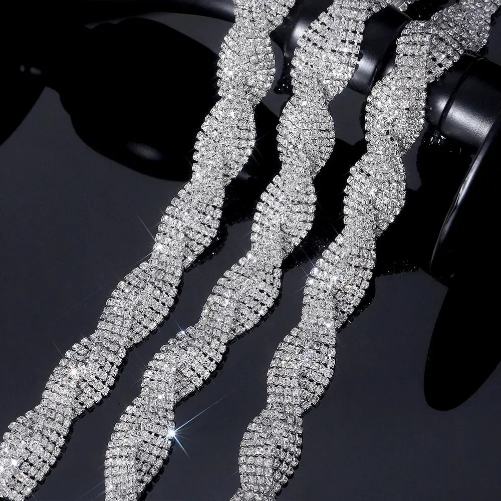 Close-up of clear glass rhinestones on silver chain trim for luxe creations.