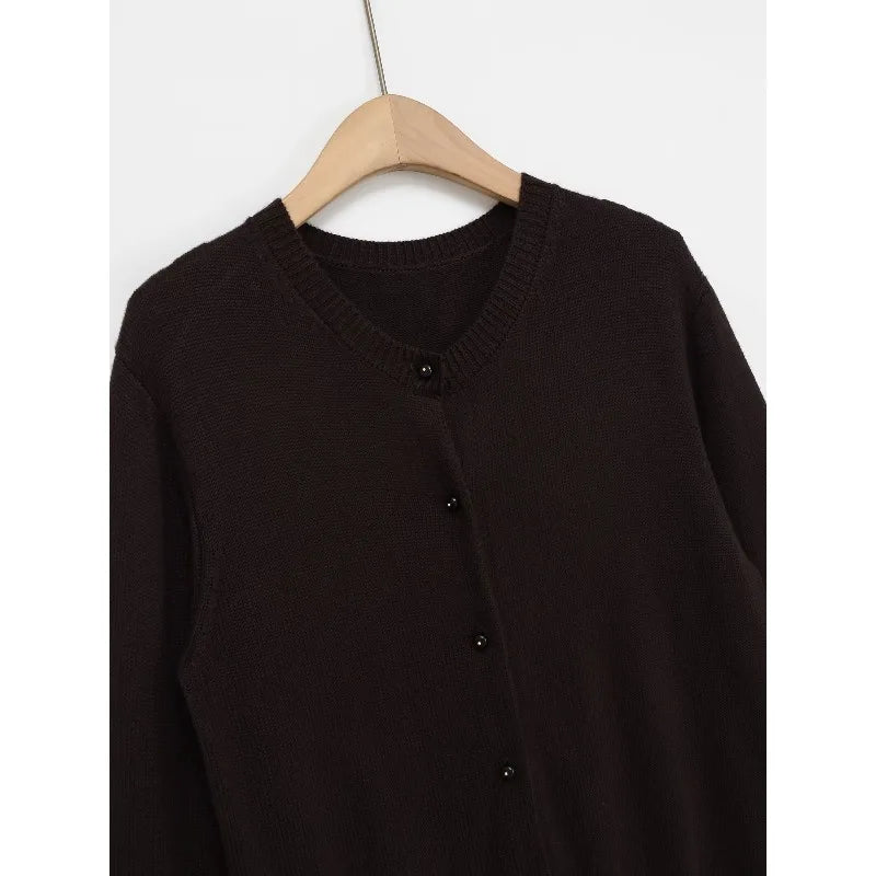 Model wearing the Autumn Whispers cardigan layered over a chic dress, perfect for transitional weather.