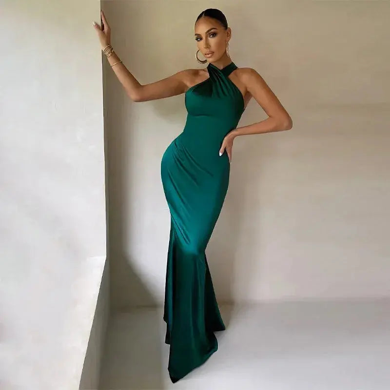Silk-blend mermaid gown in deep navy with elegant halter neckline and backless design.