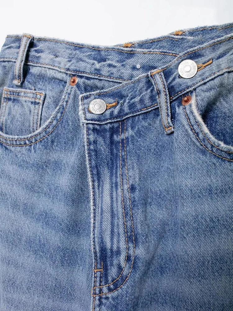 Model showcasing bold asymmetric wide-leg jeans with a dramatic silhouette.