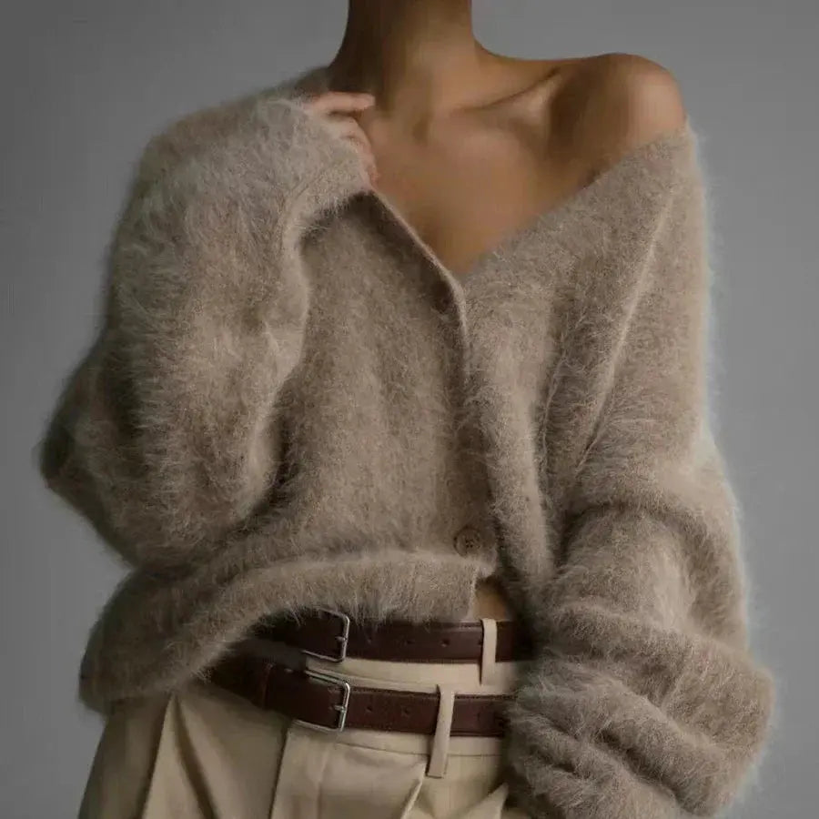 Soft beige cardigan with elegant V-neck and button detail, perfect for autumn evenings.