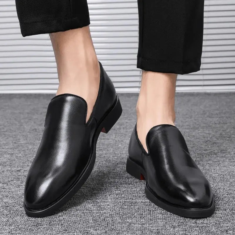 Side view of men's dress loafers with bold red sole accent and sleek faux leather construction