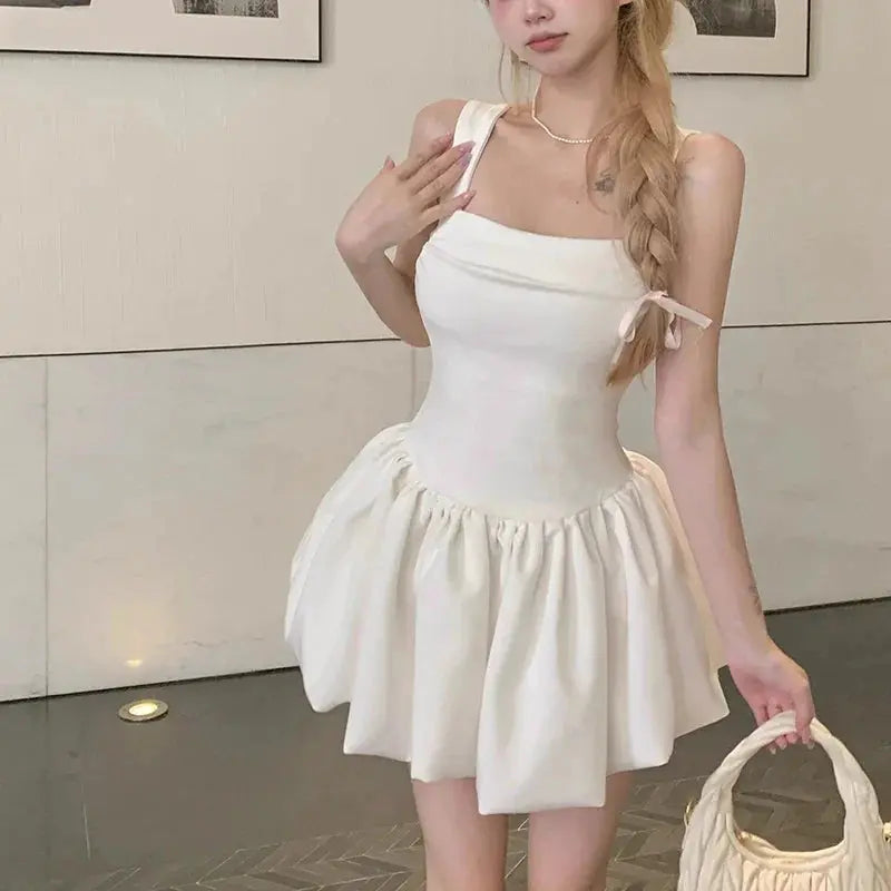 Close-up of the ruched bodice and bubble hem of the mini dress.