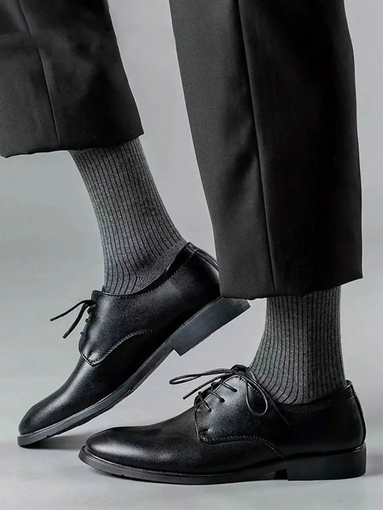Elegant navy dress socks complementing leather shoes, ideal for boardroom essentials.