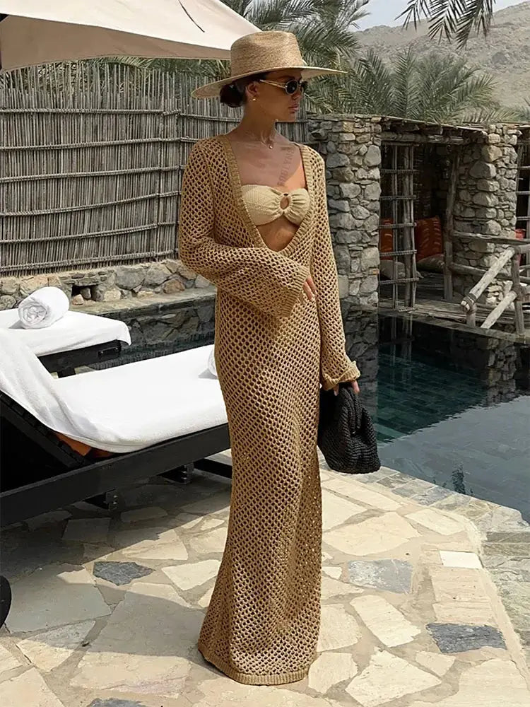 Whisper of Waves Crochet Maxi Cover-Up draped over a beach chair, illustrating its lightweight and elegant design.