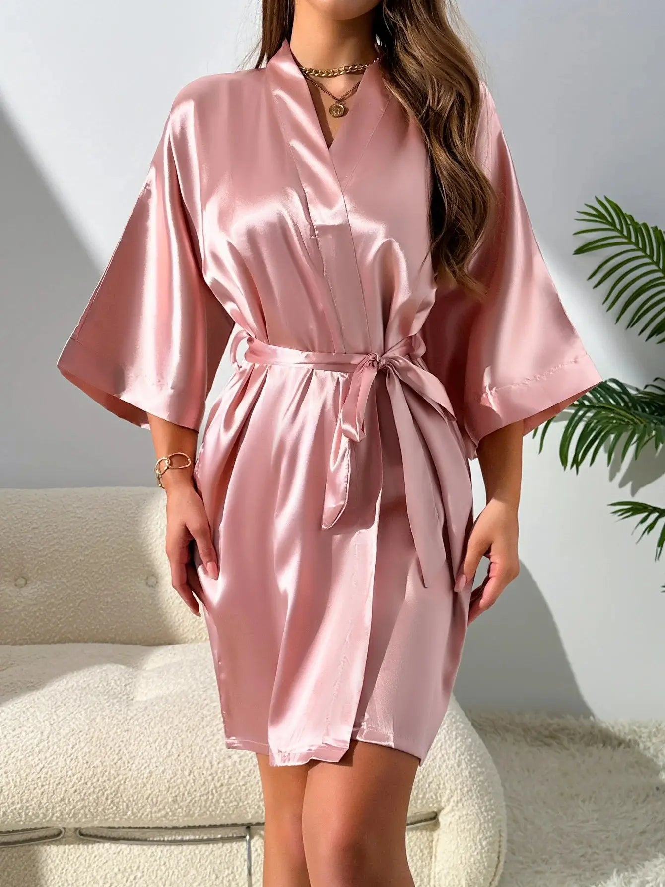 Flat lay of the three-piece pajama set, including robe, V-neck top, and shorts in a stylish arrangement.