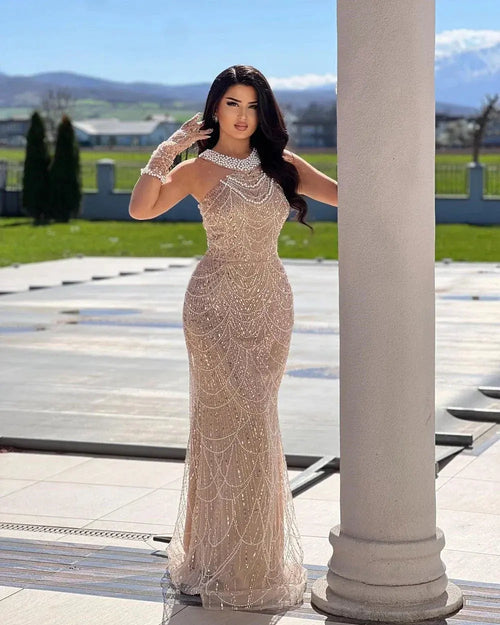 Elegant pearl-embellished mermaid gown with a satin finish and sequined bodice.