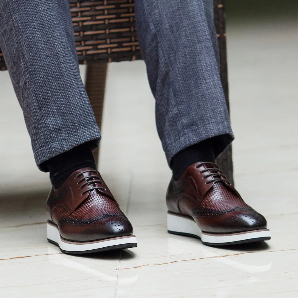 Side view of genuine leather derby shoes displaying elegant brogue detailing and secure lace-up design