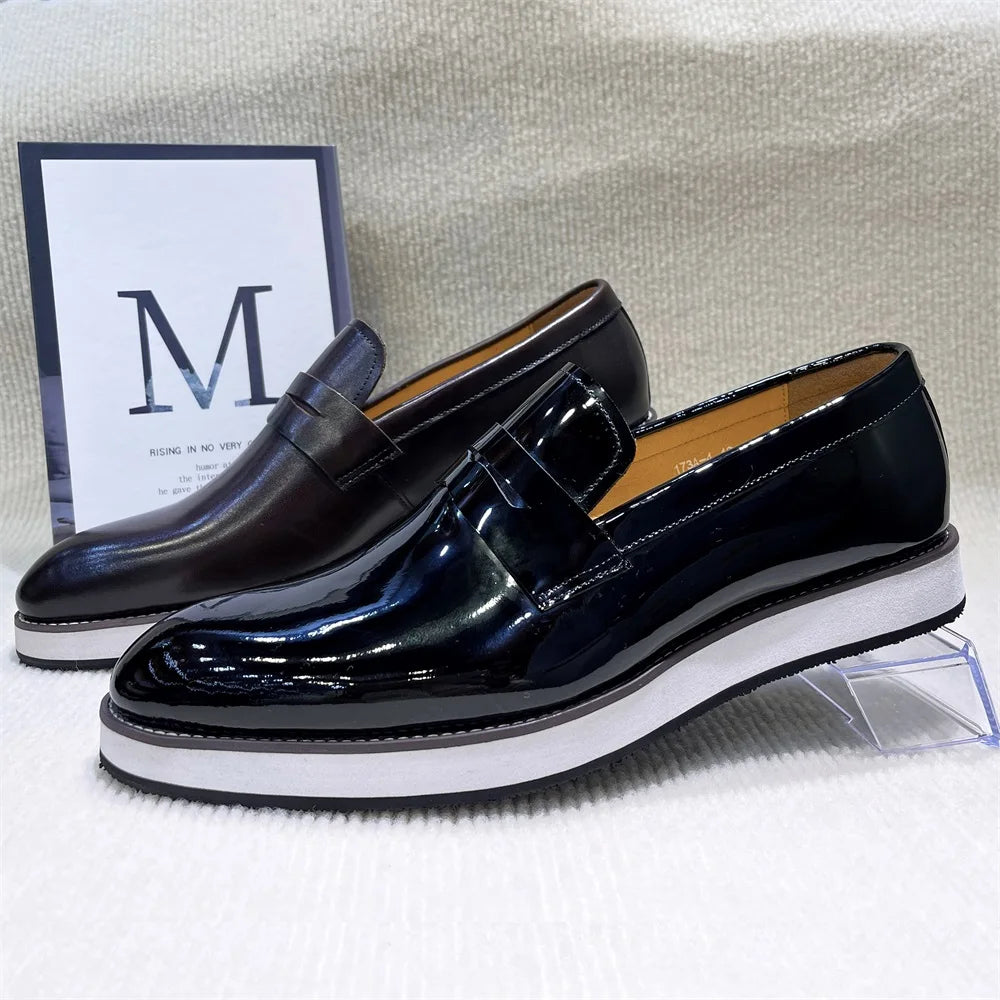 Black pointed toe leather loafers with sleek silhouette for professional business attire