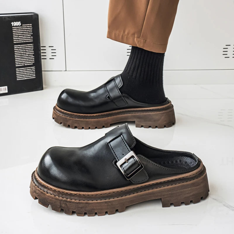 Side view of slip-on leather mules showing platform sole and designer hardware
