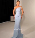 Close-up of hand-applied rhinestones on the strapless mermaid gown, sparkling under light.