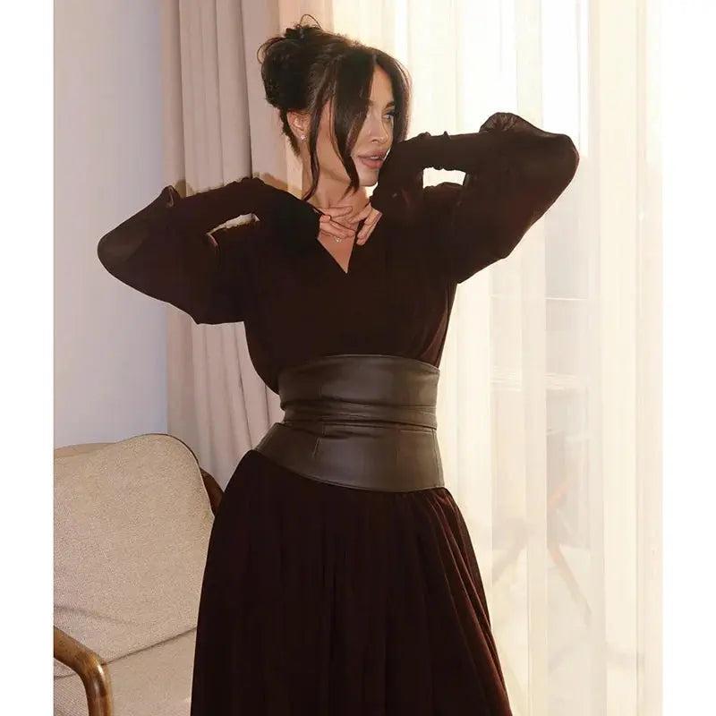 Gracefully pleated hem on a sleek maxi dress, enhancing movement and elegance.