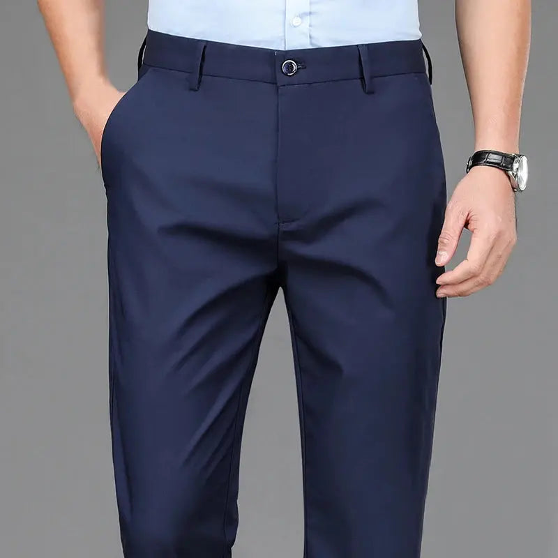 Model wearing streamlined fit trousers in a boardroom setting.