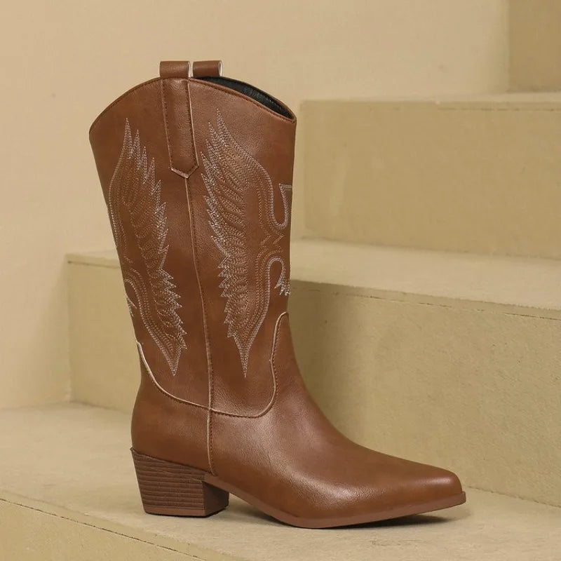 Tan embroidered Western boots with traditional frontier-style decorative stitching