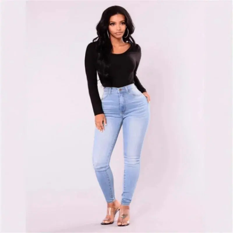Model in Contour High-Waist Jeans paired with an elegant blouse for a night out.
