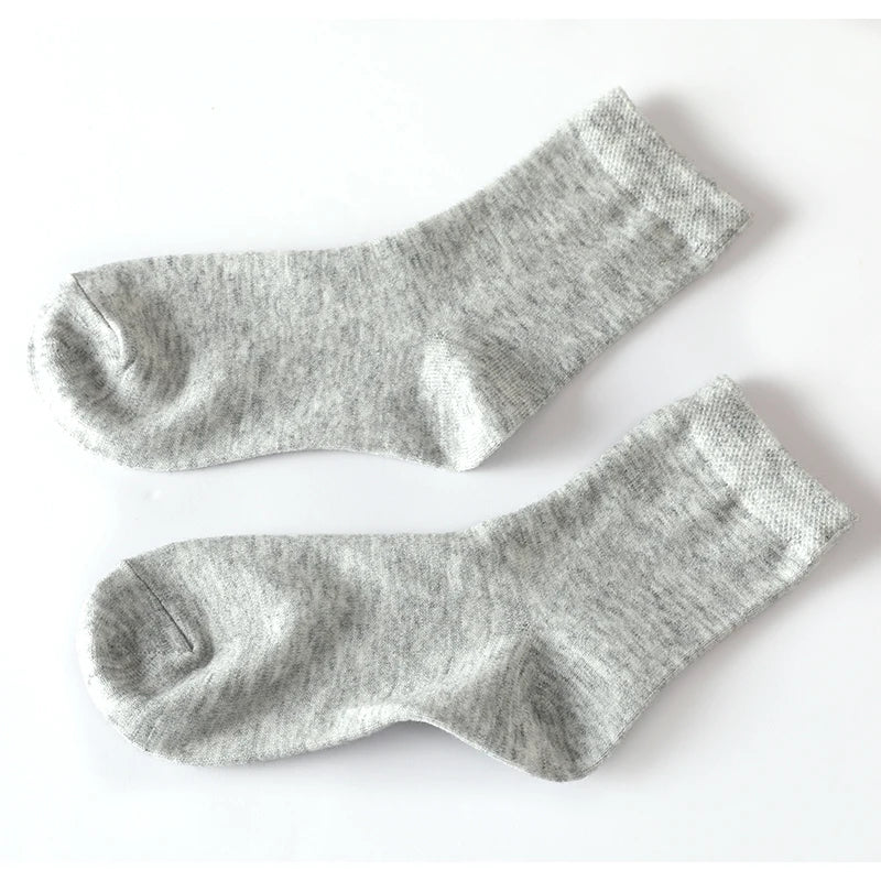 Whisper-soft cashmere socks in neutral color, perfect for winter warmth and comfort.
