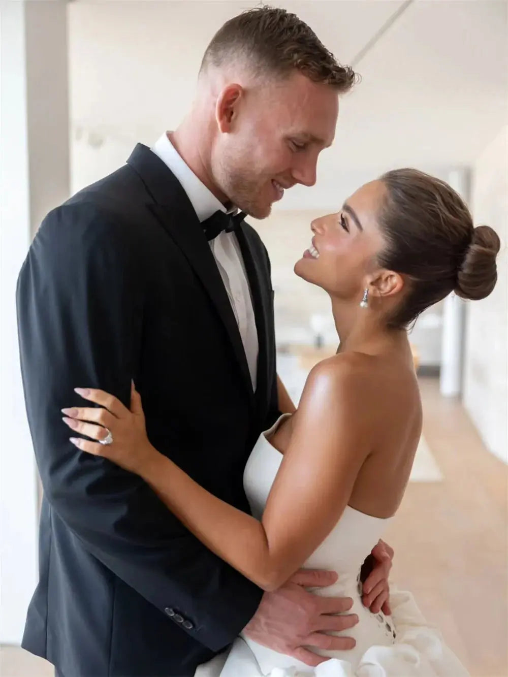 Bride wearing the satin elegance gown, radiating poise and beauty on her wedding day.