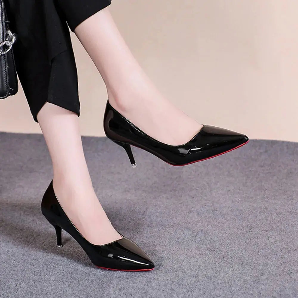 Black pointed heels paired with a formal dress, perfect for evening events.