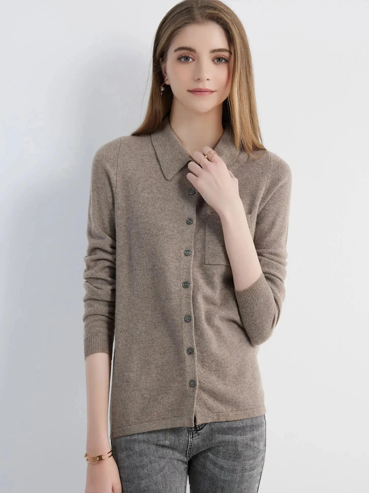 Image of the cardigan draped over a chair, highlighting its luxurious fabric and color.