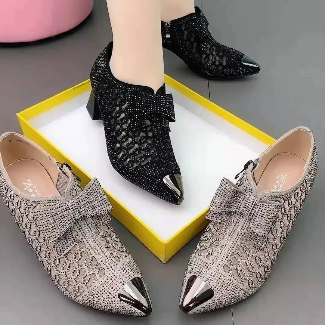 Side view of stylish black bow pumps, highlighting their medium heel and elegance.