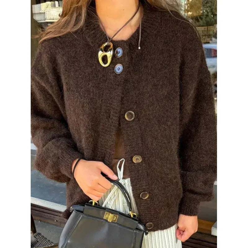 Cozy chunky knit cardigan in warm autumn hues with wooden buttons and fringe trim.