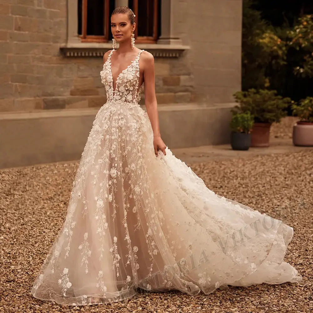 Whisper of Elegance lace wedding dress with deep V-neck and spaghetti straps in ivory.