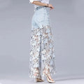 Wide-leg jeans in light denim with lace details and a high waist, perfect for breezy evening strolls.