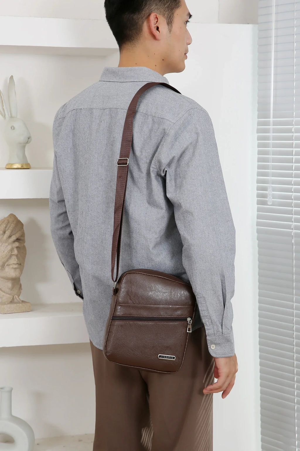 Crossbody bag with bucket shape maximizing capacity while maintaining streamlined appearance
