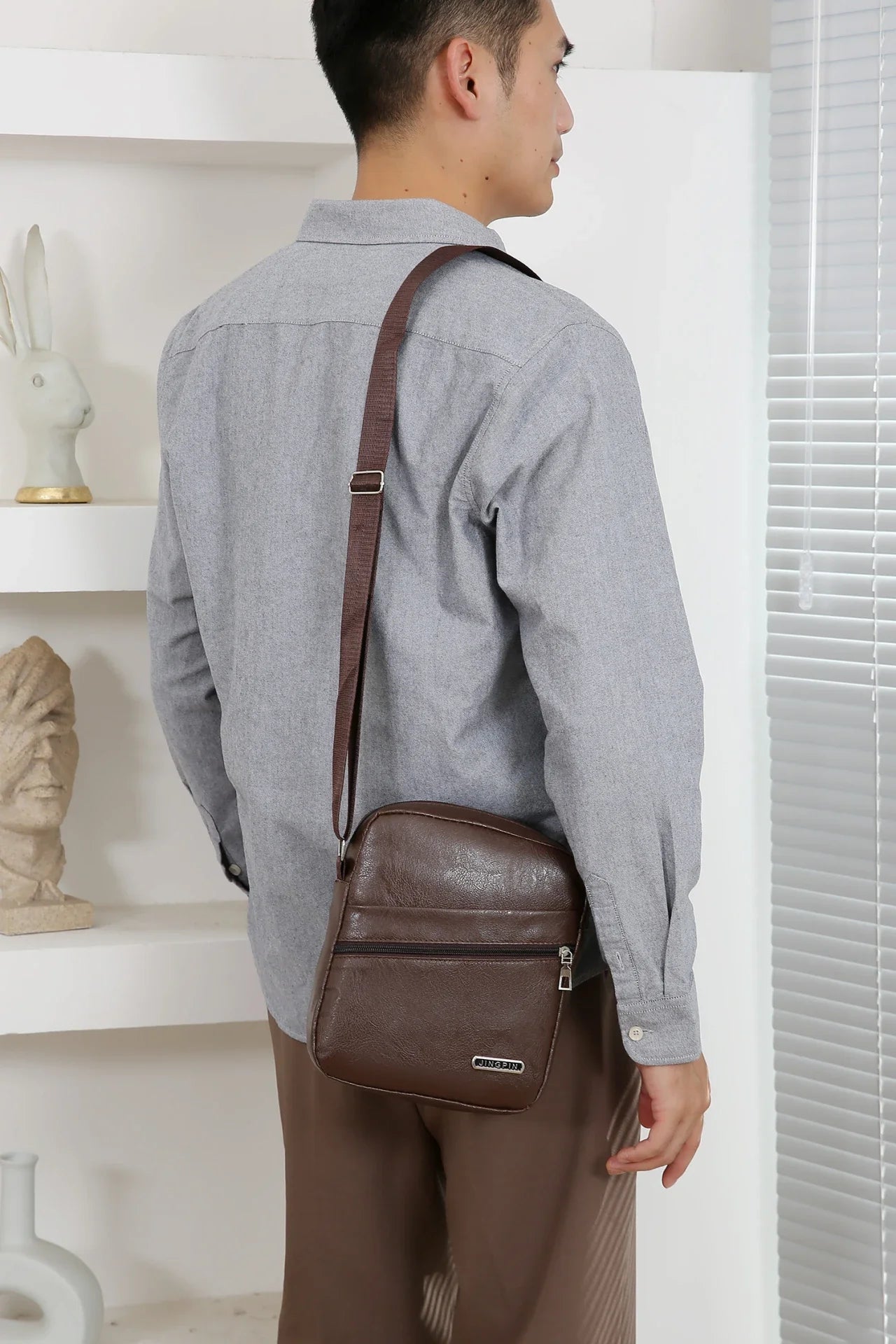 Crossbody bag with bucket shape maximizing capacity while maintaining streamlined appearance