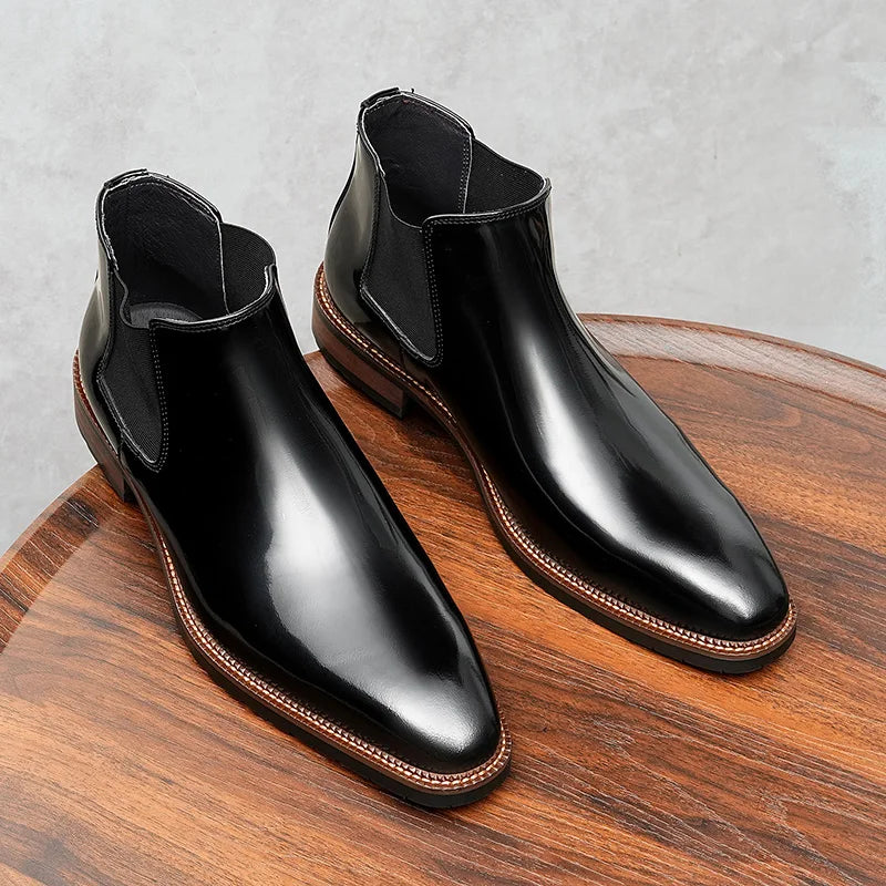 Detail of burgundy glossy leather Chelsea boot highlighting luxurious finish and craftsmanship