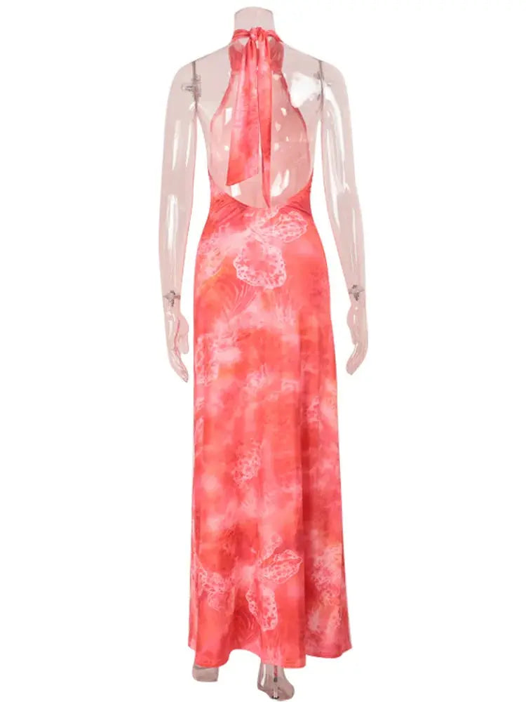 Form-fitting dress with halter neck, sheer mesh print, and show-stopping open back design