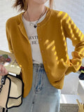 Cozy Chic Cardigan styled with jeans, showcasing its essential wardrobe piece appeal.