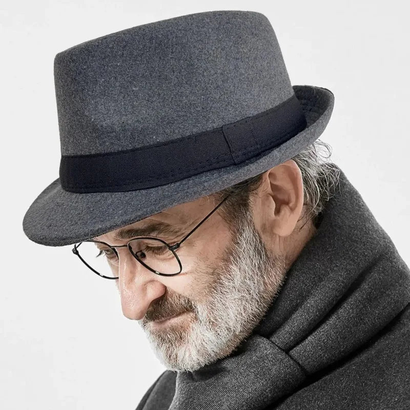 Charcoal Whispers Fedora displayed on a wooden table, emphasizing its versatile color palette.