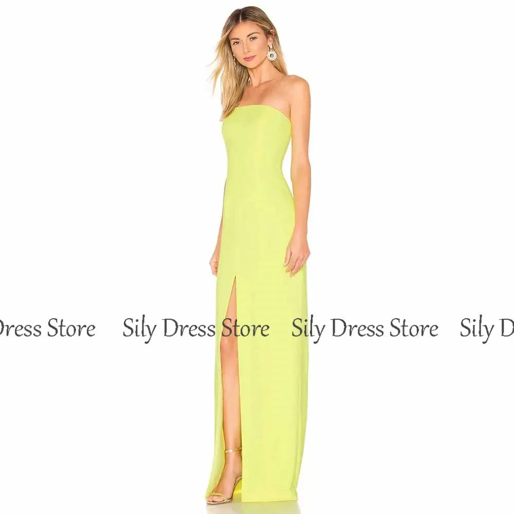 Model wearing the emerald gown, demonstrating its confident fit and bold front split at a formal event.