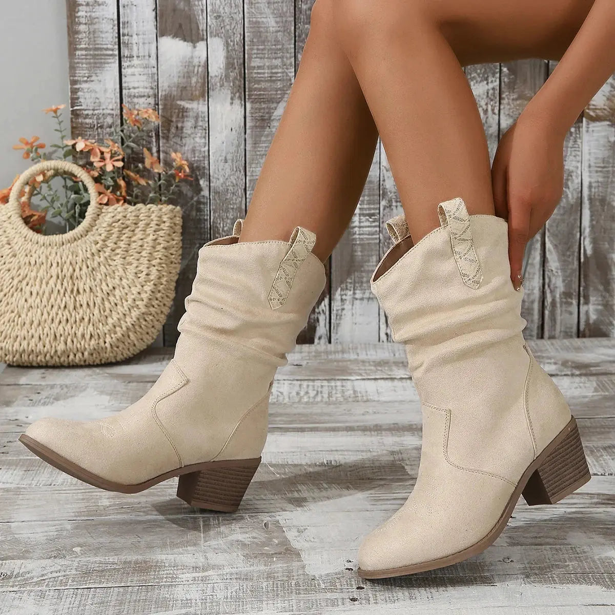 Versatile Western-style boots with slip-on design and mid-calf silhouette for spring and fall