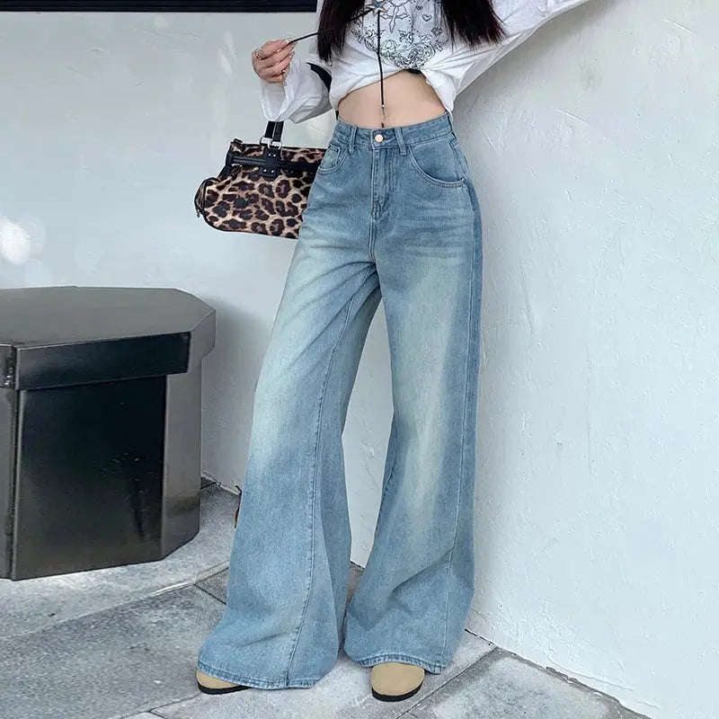 Detail of distressing on Sunset Hues Wide-Leg Jeans, adding character.