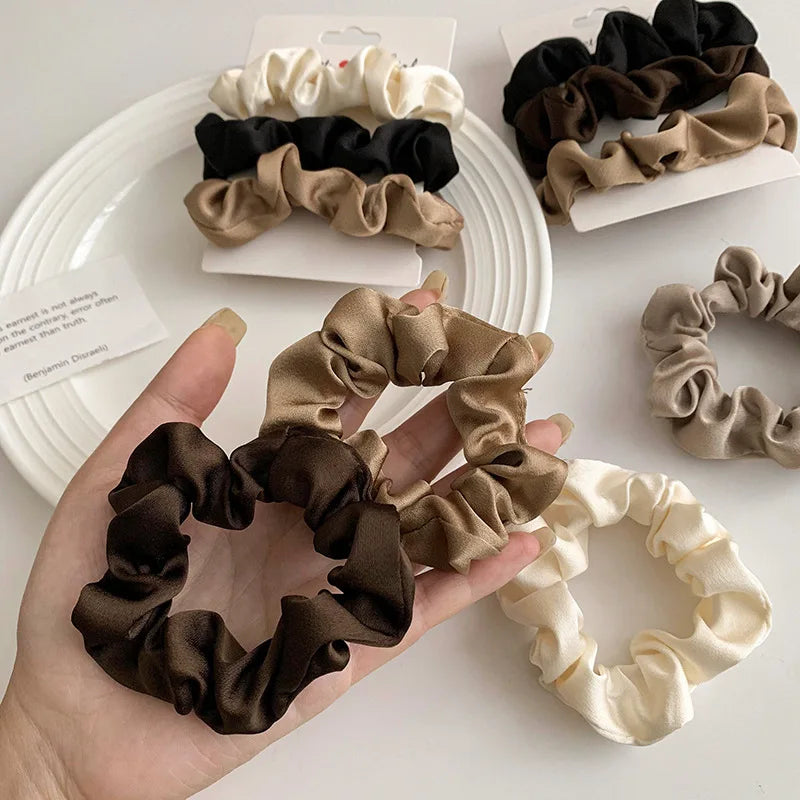 Premium satin scrunchies preventing hair breakage and creasing during all-day wear