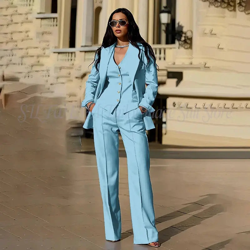 Model wearing the tailored suit with a stylish handbag.