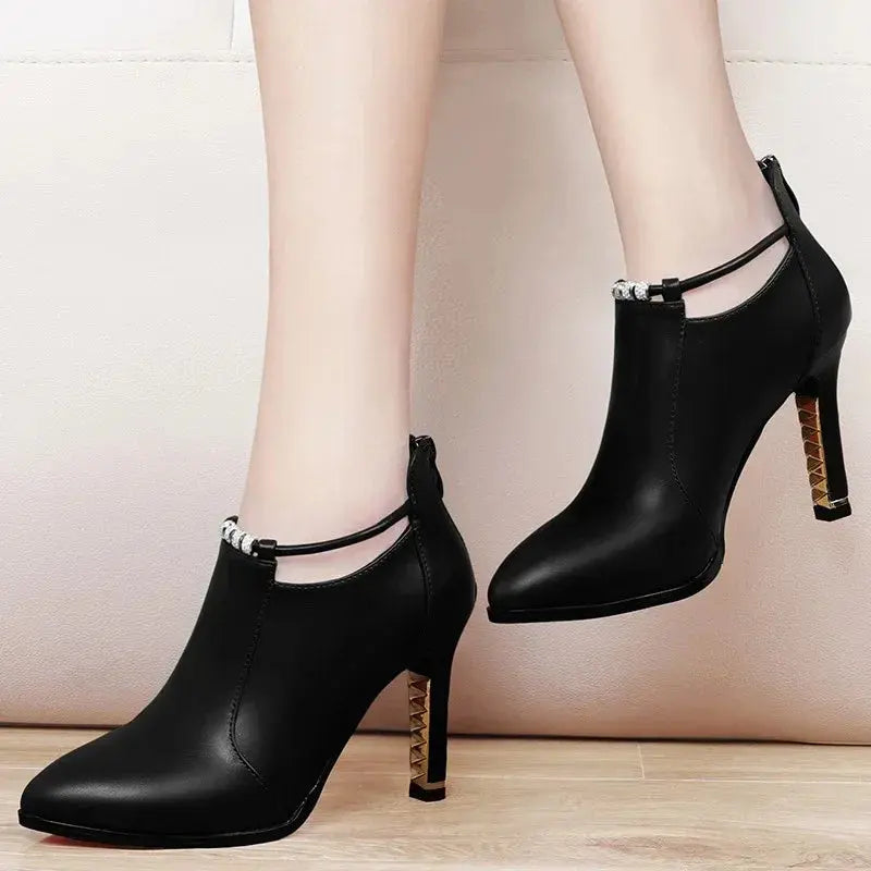 Back view of the red stiletto ankle boots highlighting the handcrafted details.