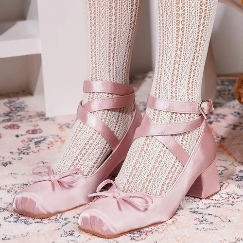 Close-up of blush satin Mary Jane heels showcasing luxurious sheen.